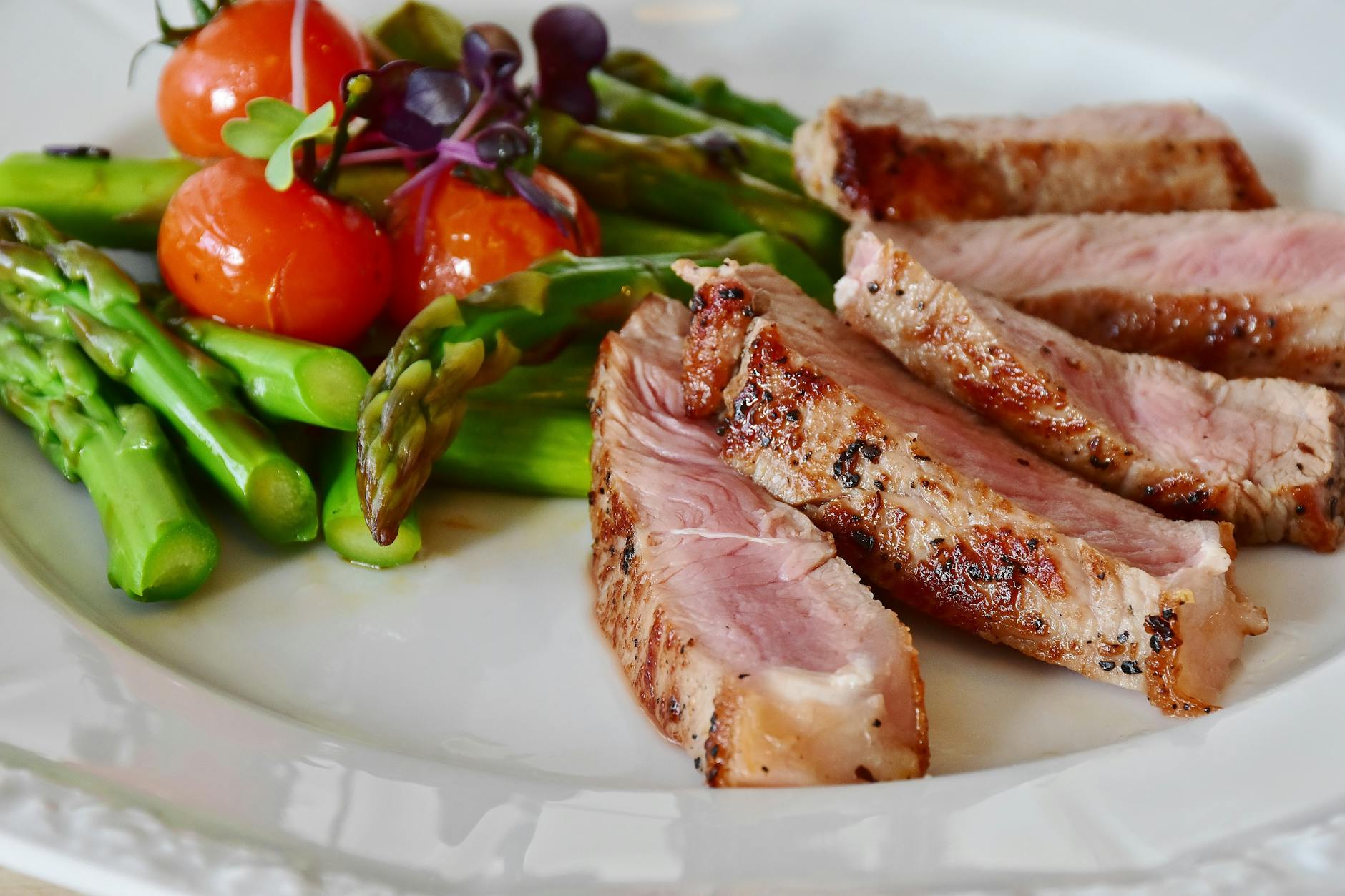 grilled meat dish served on white plate